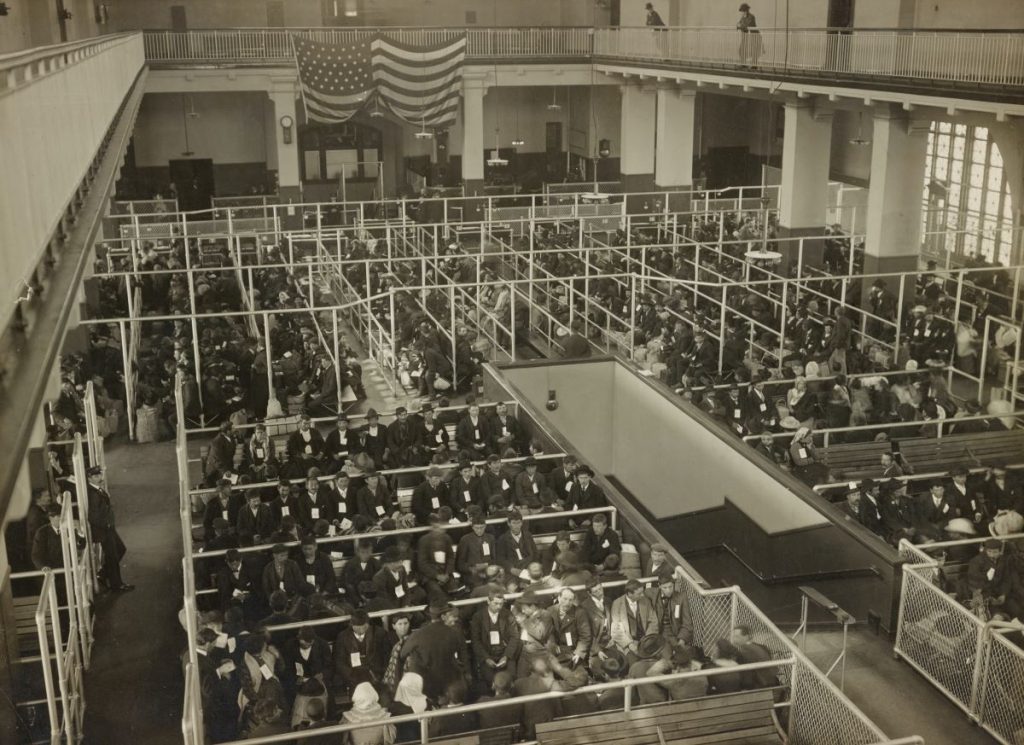 A large line of people going through immigration in USA.