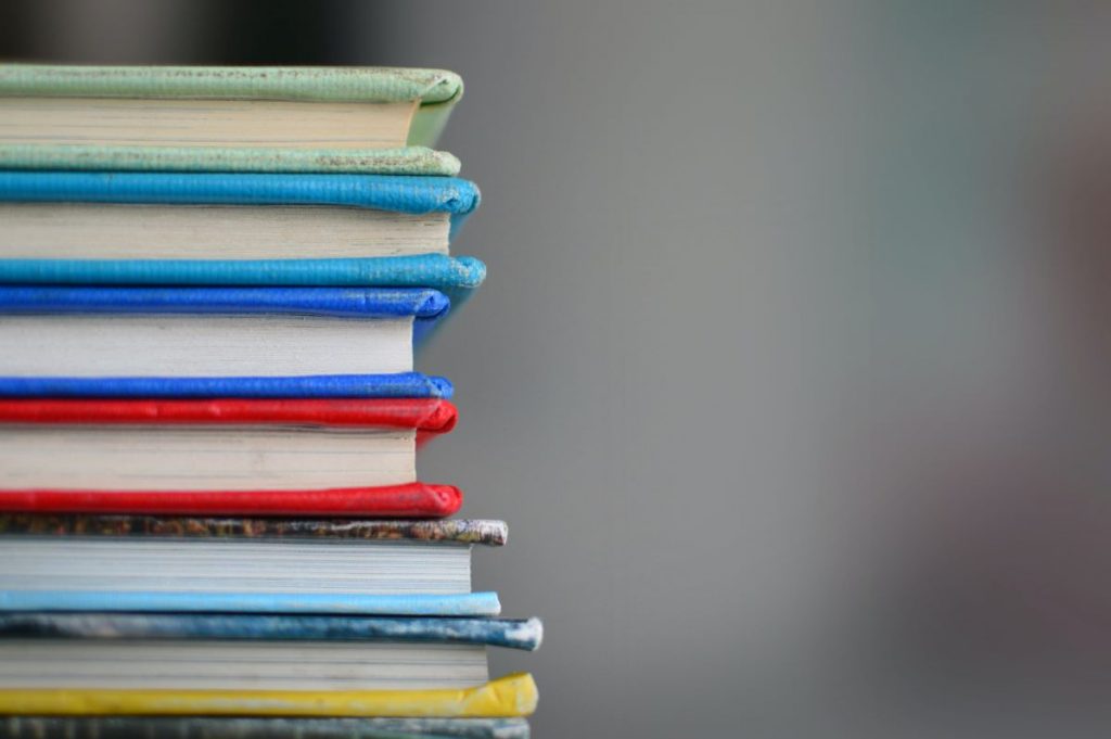 A stack of colorful hardcover books, from one of the best bookstores in Dublin - sweny´s pharmacy
