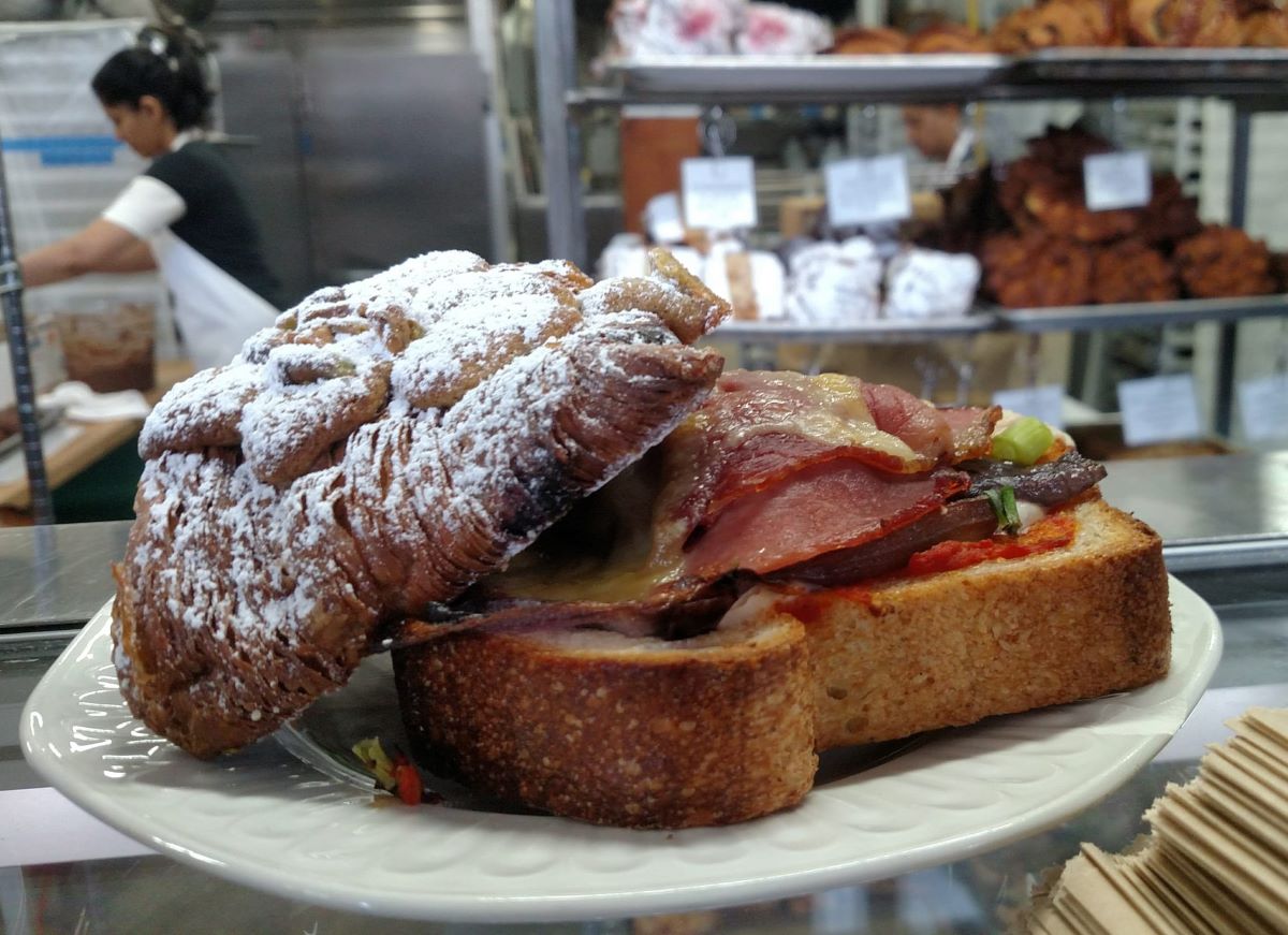 Zoomed in photo with focus on a powdered croissant and savory special of the day.