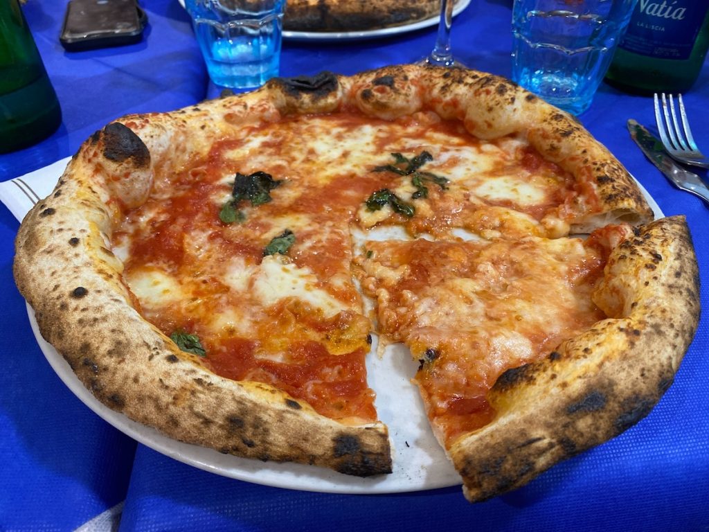 what is naples italy known for? Neopolitan pizza of course. A margarita pizza with thin base but fluffy crust, with fresh basil