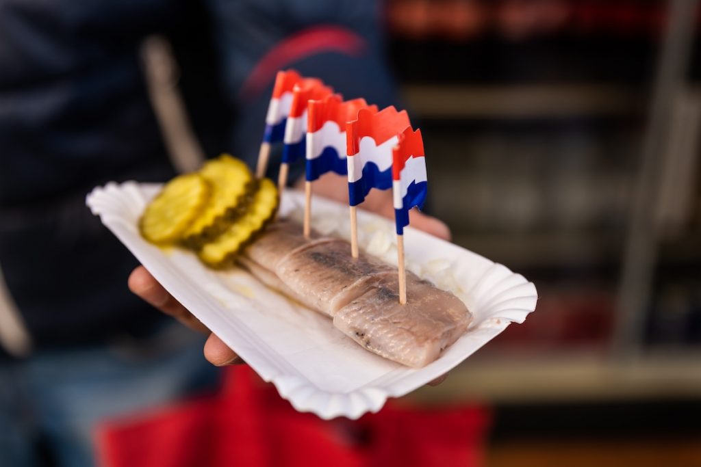 A plate of herring is a typical choice when it comes to traditional food in Amsterdam.