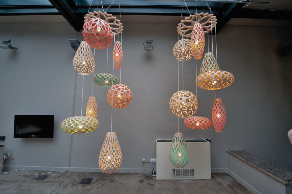 ornate lattice lamps in pastel shades, hanging from a ceiling, part of the annual salone de mobile event which is another reason why Milan is worth visiting.