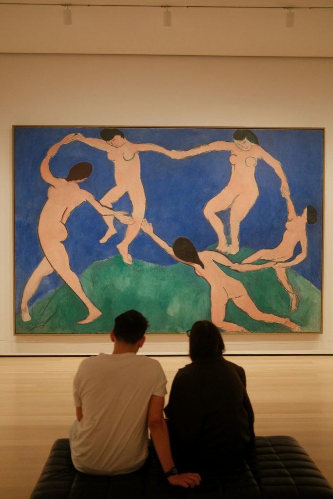 People looking at Matisse’s”Dance and the MoMA.