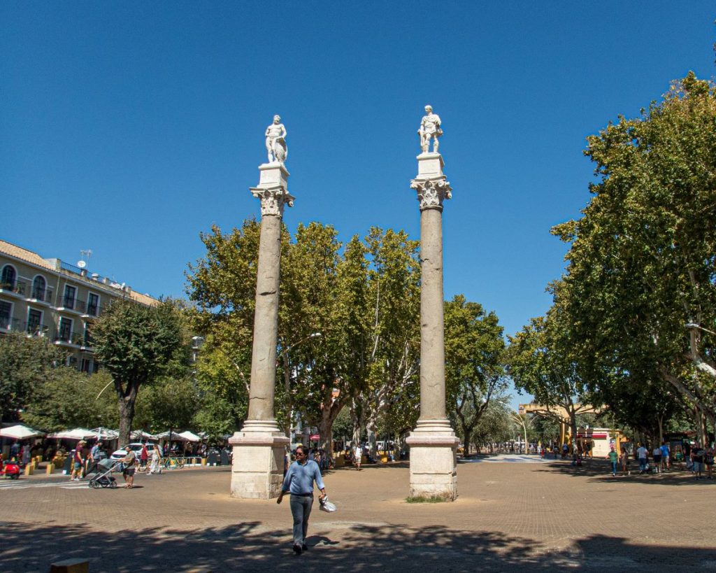 People walking around Alameda de Hercules in Seville.
