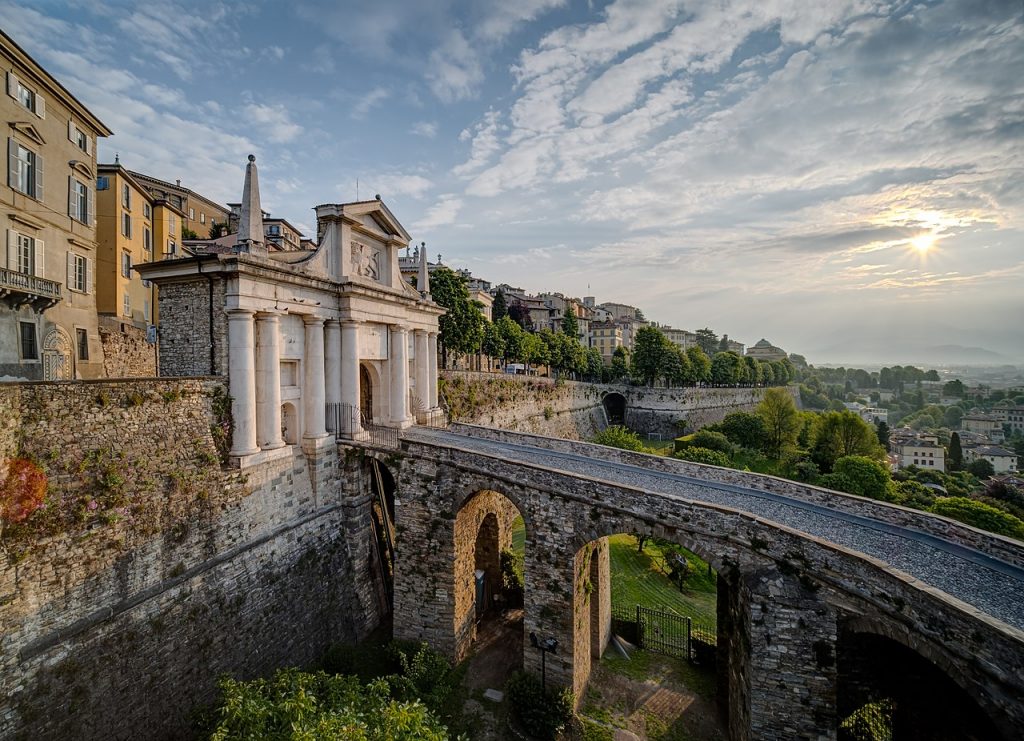 View of a curving bridge that leads to Città Alta in Bergamo, Italy.