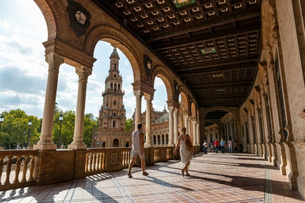 People walking around and exploring Plaza de España.