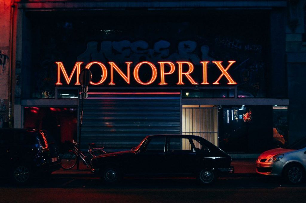A Monoprix neon sign after the store has closed in Paris.