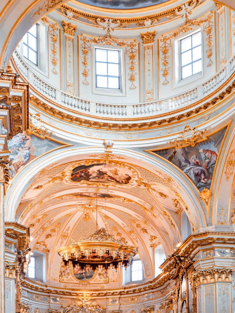 An ancient Italian church's ceiling with paintings in Bergamo.