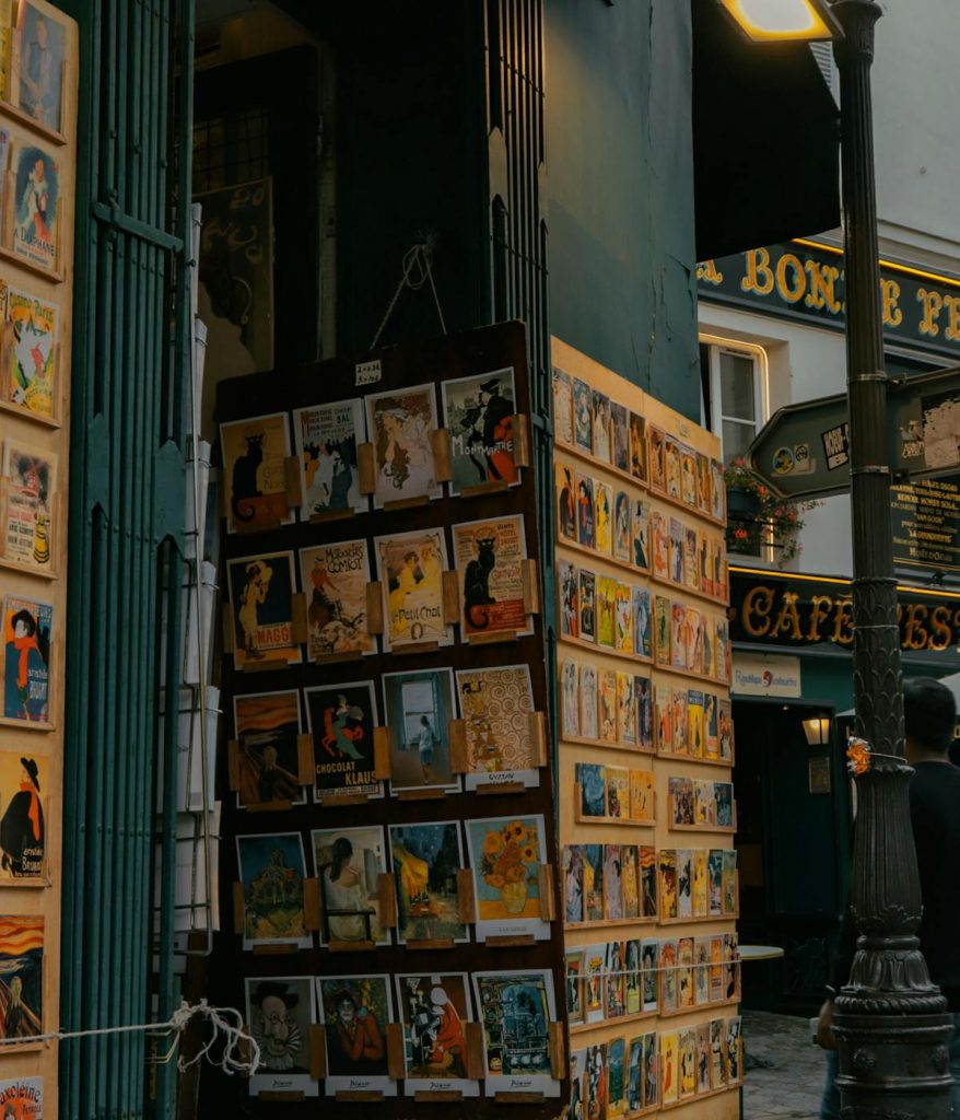 A storefront with lots of artwork from Paris.