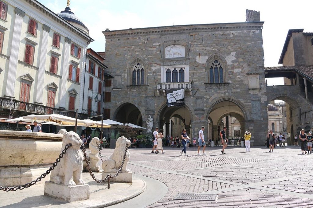 People walking around in Piazza Vecchia, Bergamo, Italy.