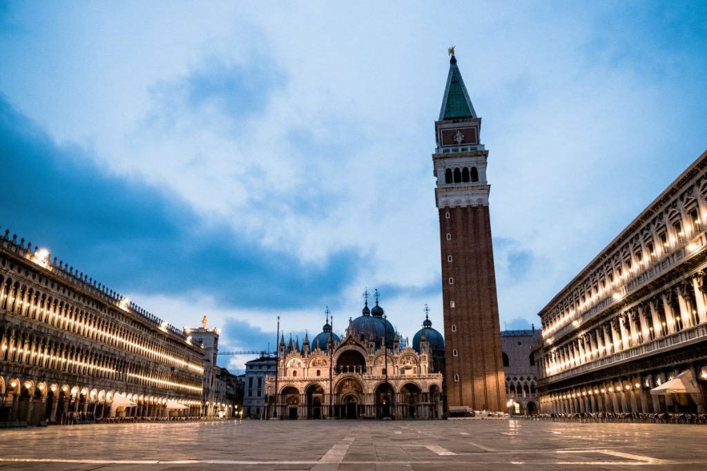 A top venice travel tip is to visit St. Mark’s Square at dawn. St. Mark’s Basilica and Campanile; the peaceful, empty square glows softly.