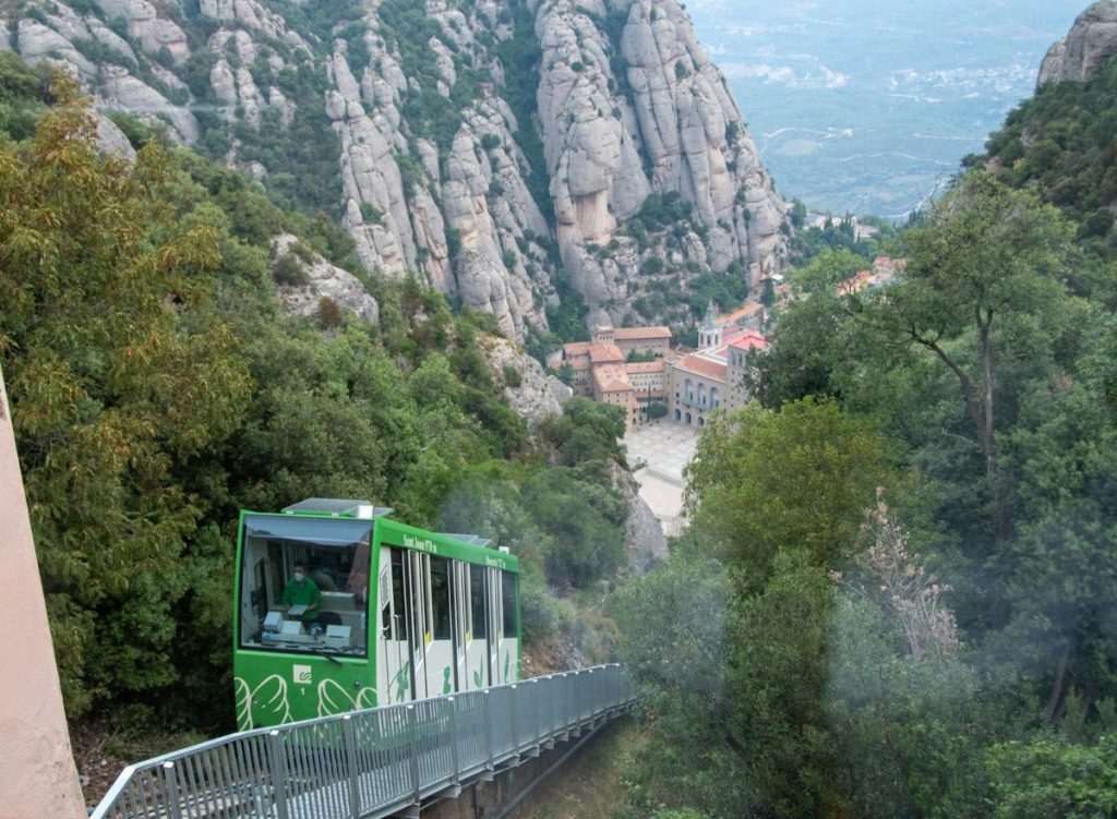 People riding up the funiculars in Montserrat.
