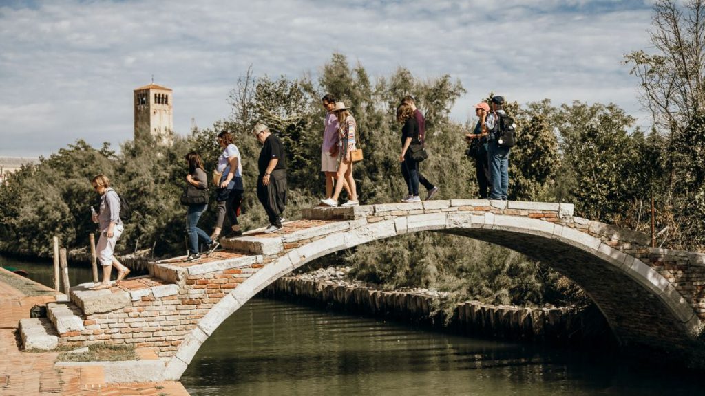 People walking over a bridge at the Venetian Islands.