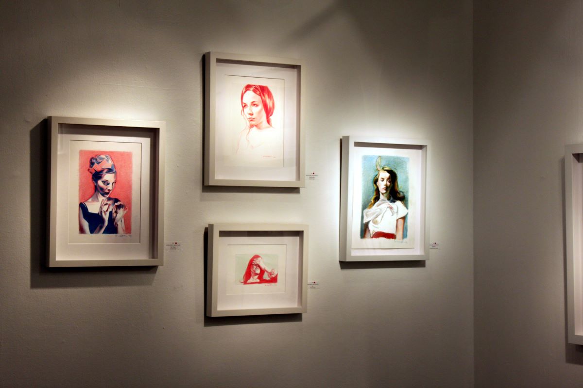 Artworks hanging on a wall by Mercedes Helnwein in Dublin art museum.
