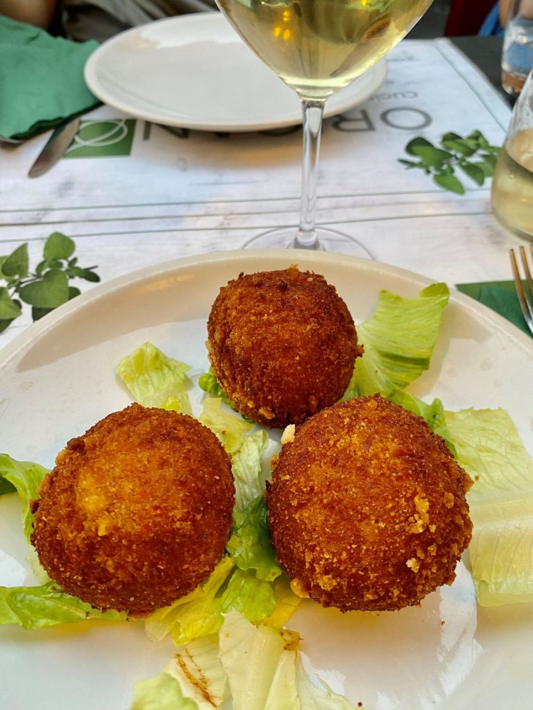 Authentic Italian Rice Balls, deepfired and served on a bed of lettuce. These are made by Supplizio, one of the best restaurants near Piazza Navona