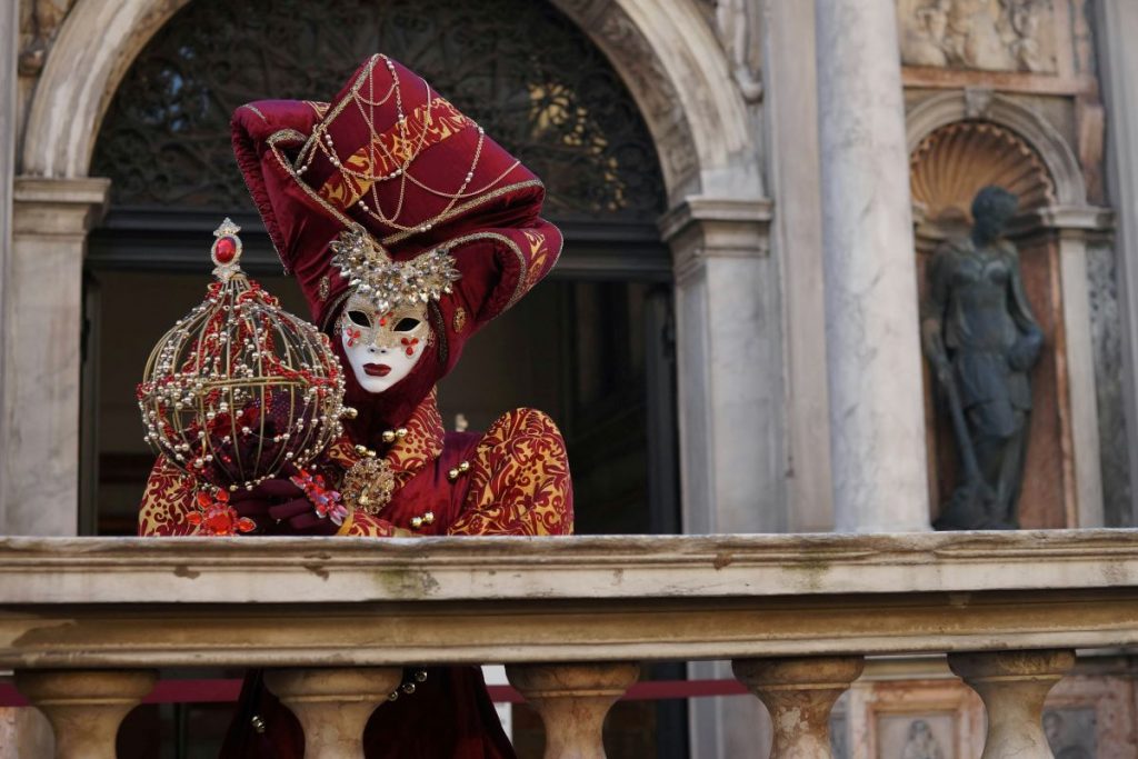 lady in ornate costume standing on balcony