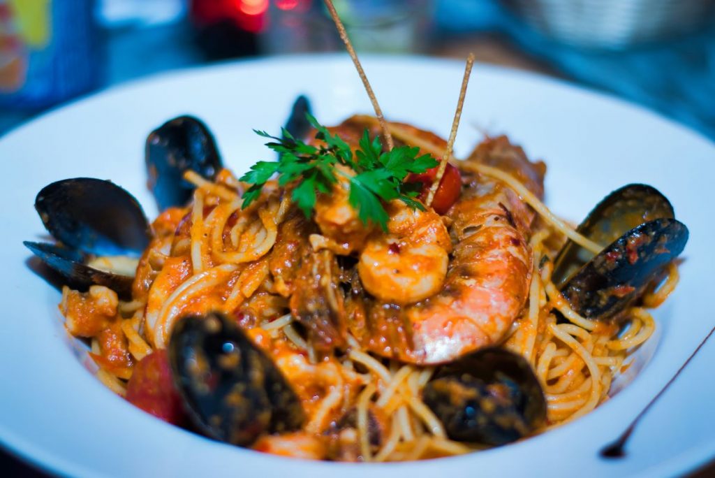 A delicious bowl of seafood pasta, with mussels, prawns and tomoato sauce, made by Pierluigi, one of the best restaurants near Piazza Navona