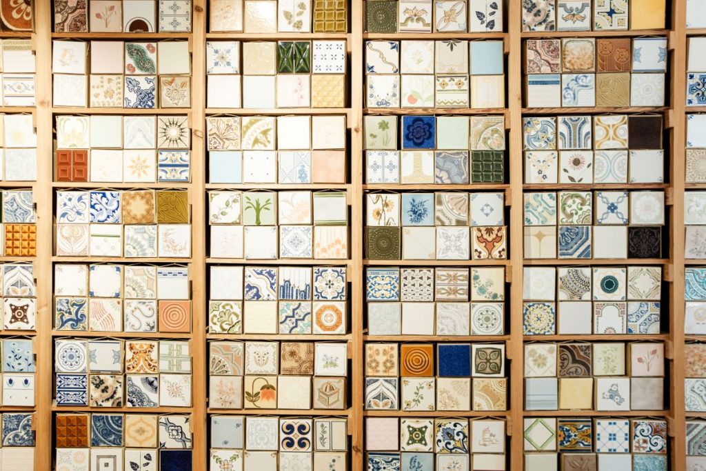 assorted traditional Portuguese tiles on display, with a variety of designed in blue, orange, brown and whites.