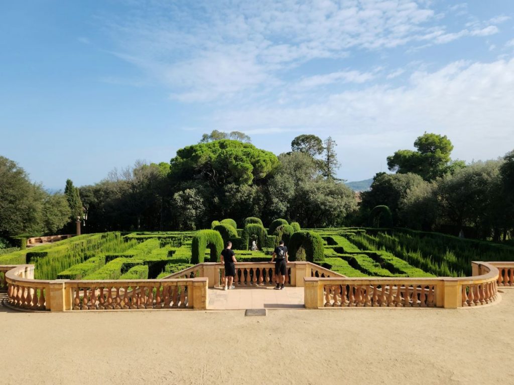 Two people at the entrance of the Labyrinth Park of Horta, one of the unusual things to do in Barcelona, Spain.