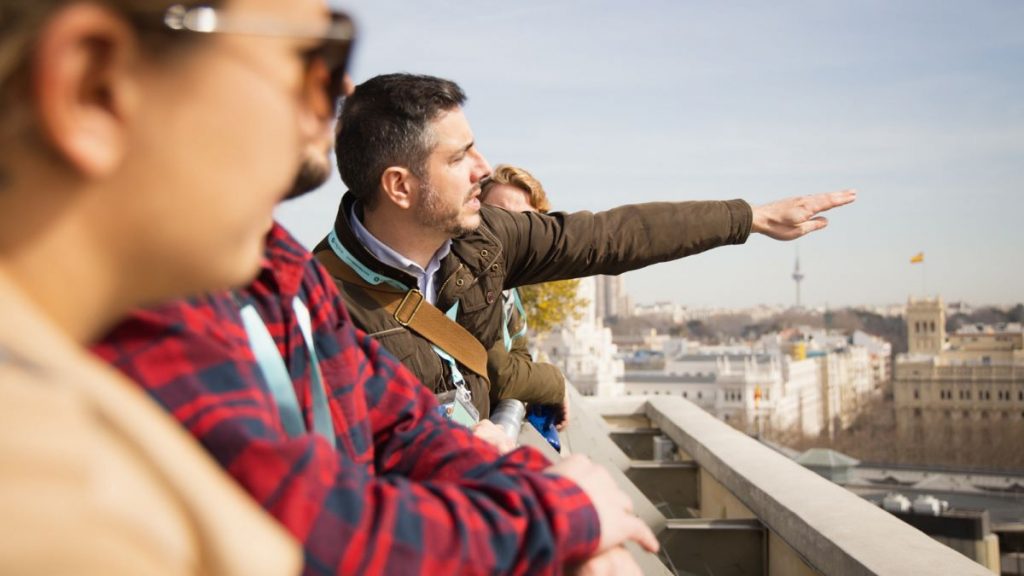 A tour guide showing clients secret views in Segovia, Spain.