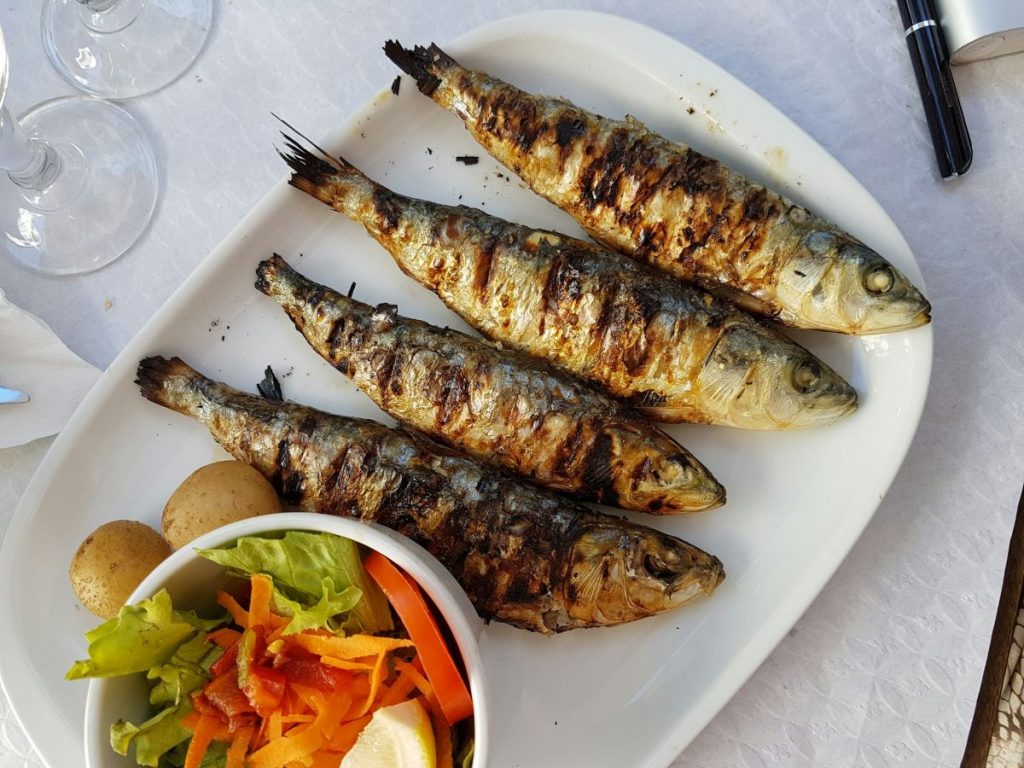 Grilled fish on a ceramic plate in Astoria, Queens.