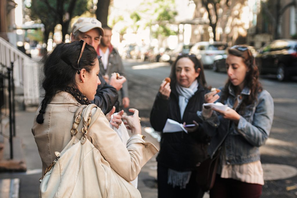 A group of people trying food outside in NYC.