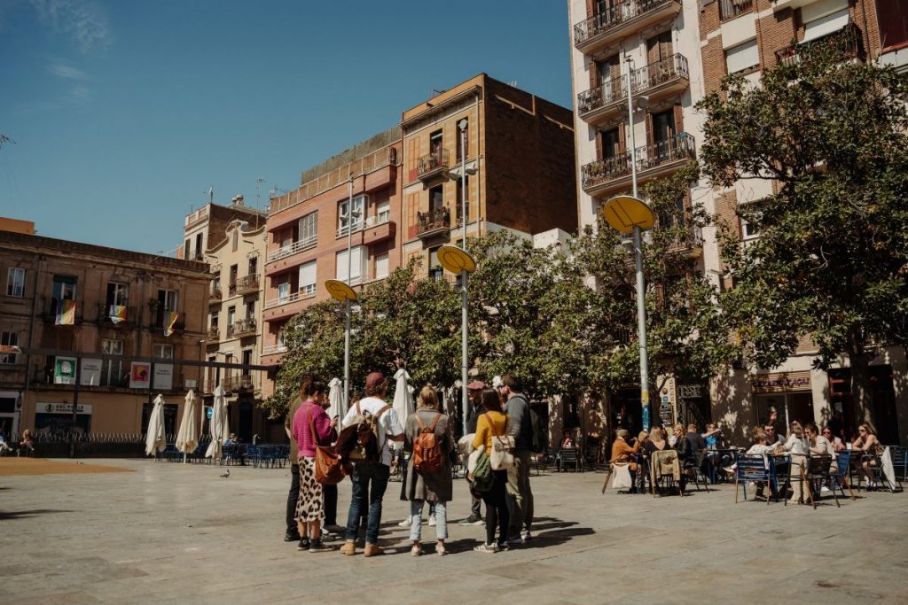People walking around the Gracia neighborhood in Barcelona.