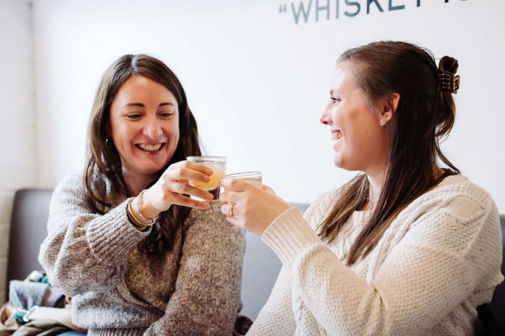 Two women enjoying a whisky tasting in Edinburgh.