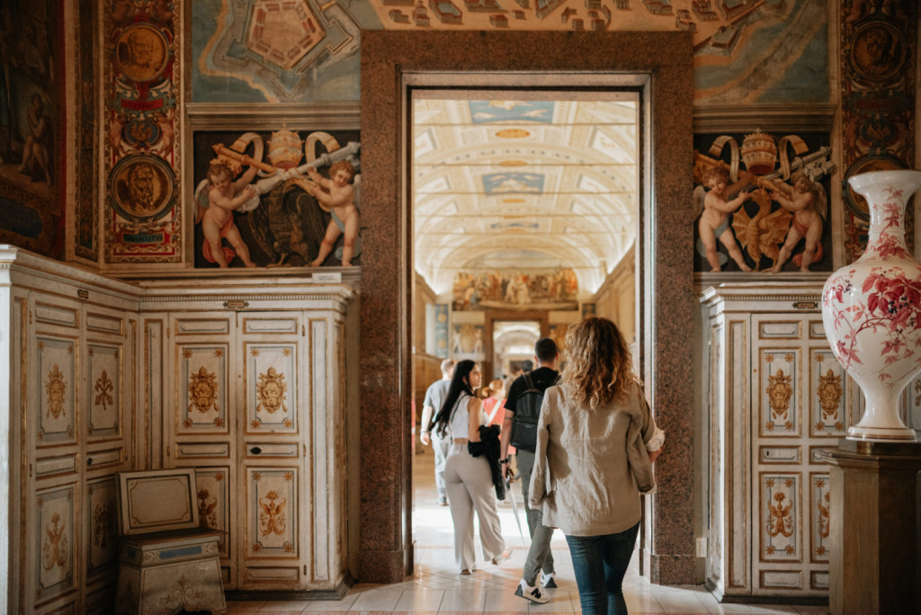 Visitors walk into the Gallery of Maps with their Sistine Chapel Guide at the Vatican Museums in Rome.