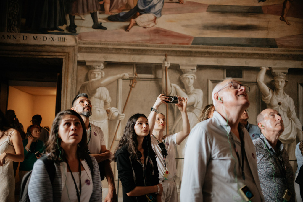 Tourists gaze at Raphael’s frescoes in the Villa Farnesina in Rome, Italy, admiring the historic ceiling paintings.